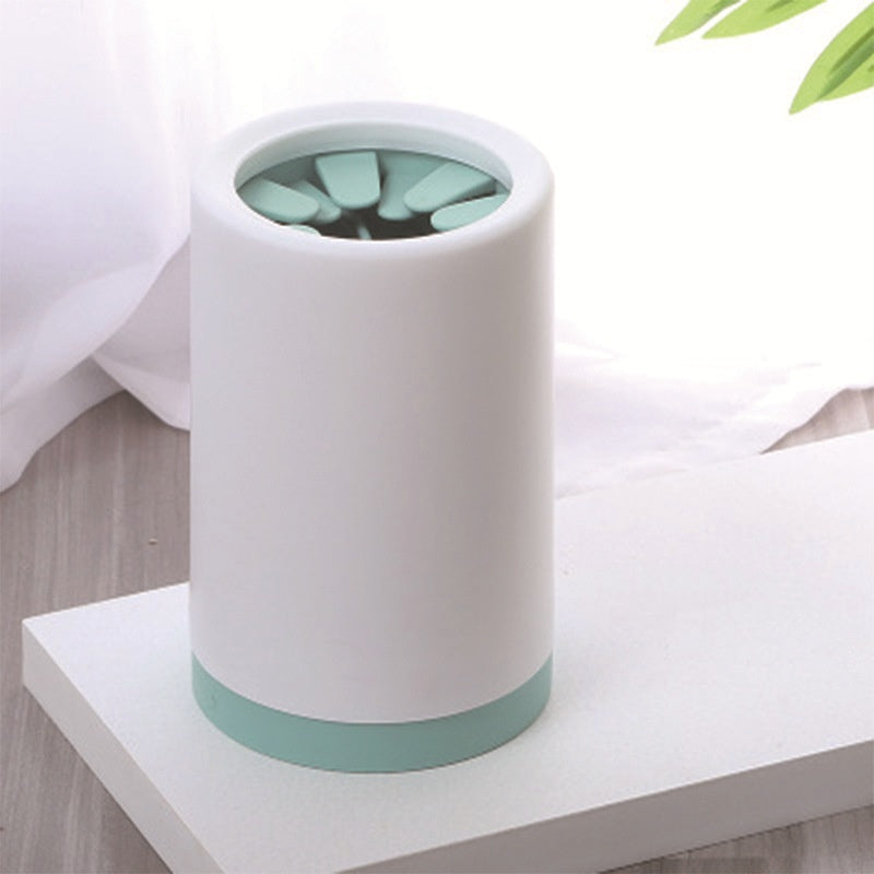 White dog paw cleaner cup with green insert and base